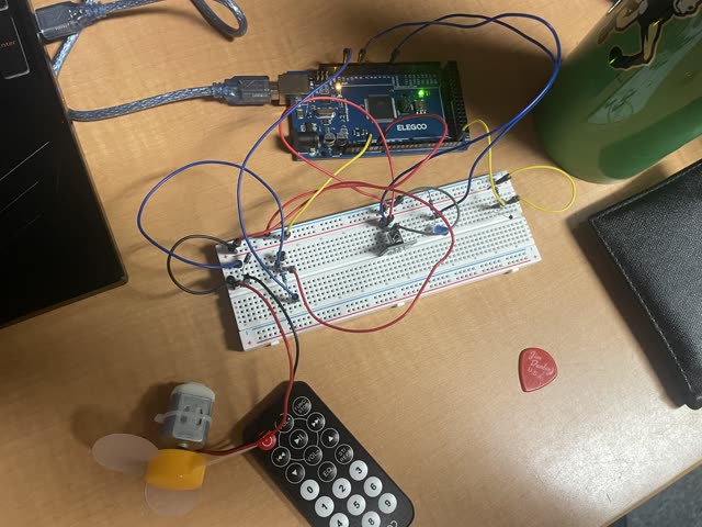 The IR-controlled temperature regulator breadboard circuit, wired to an ELEGOO Mega, with the IR remote and cooling fan.